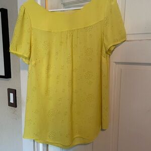 Anthropologie bright yellow top. With laser cut outs.